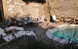 Lower terrace and pool with comfortable seating and sun loungers